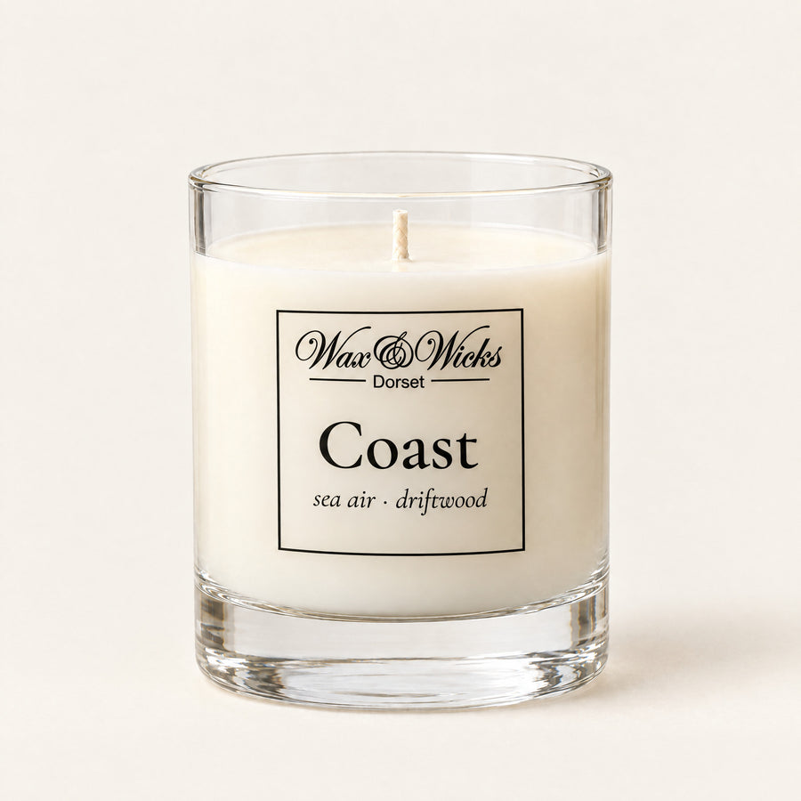 Small Coast candle, one wick, in a clear glass jar, on a plain ivory background
