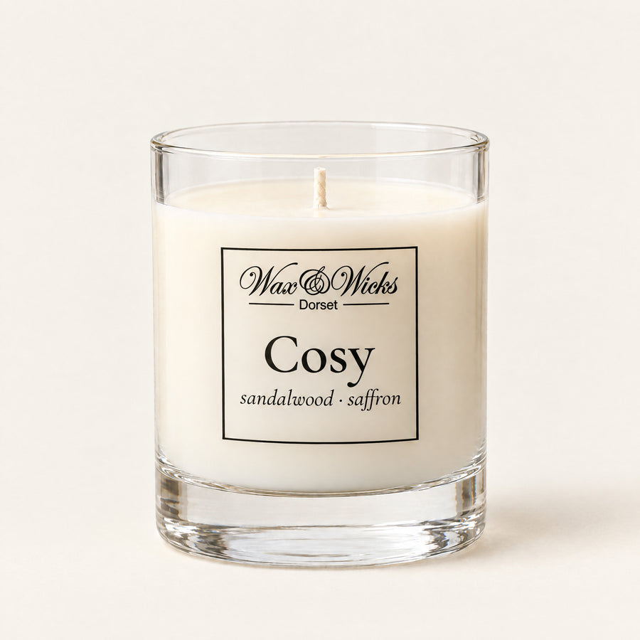 Small Cosy candle, one wick, in a clear glass jar, on a plain ivory background