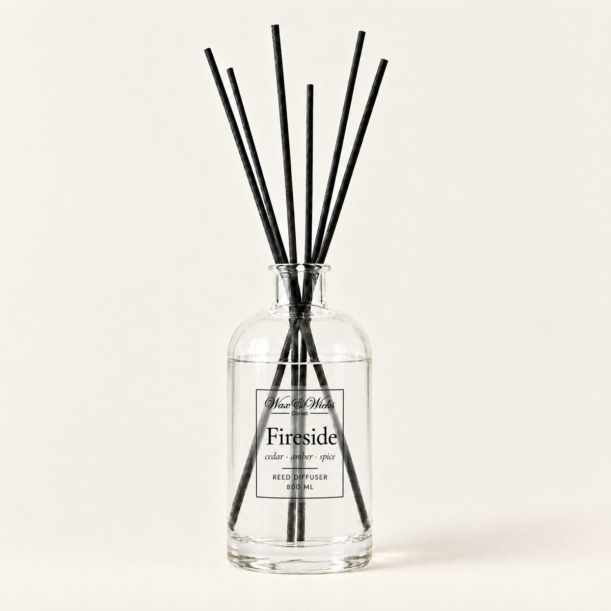 Fireside 800 ml large reed diffuser in apothecary-style glass with extra-long reeds, on a plain ivory background