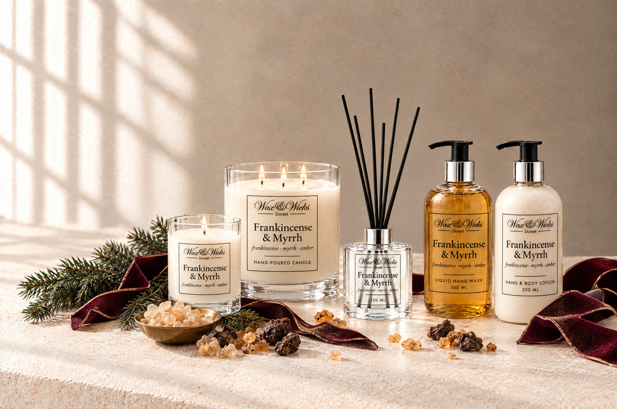 Frankincense & Myrrh candles and home fragrance together, styled with frankincense and myrrh resin, a fir sprig and burgundy ribbon
