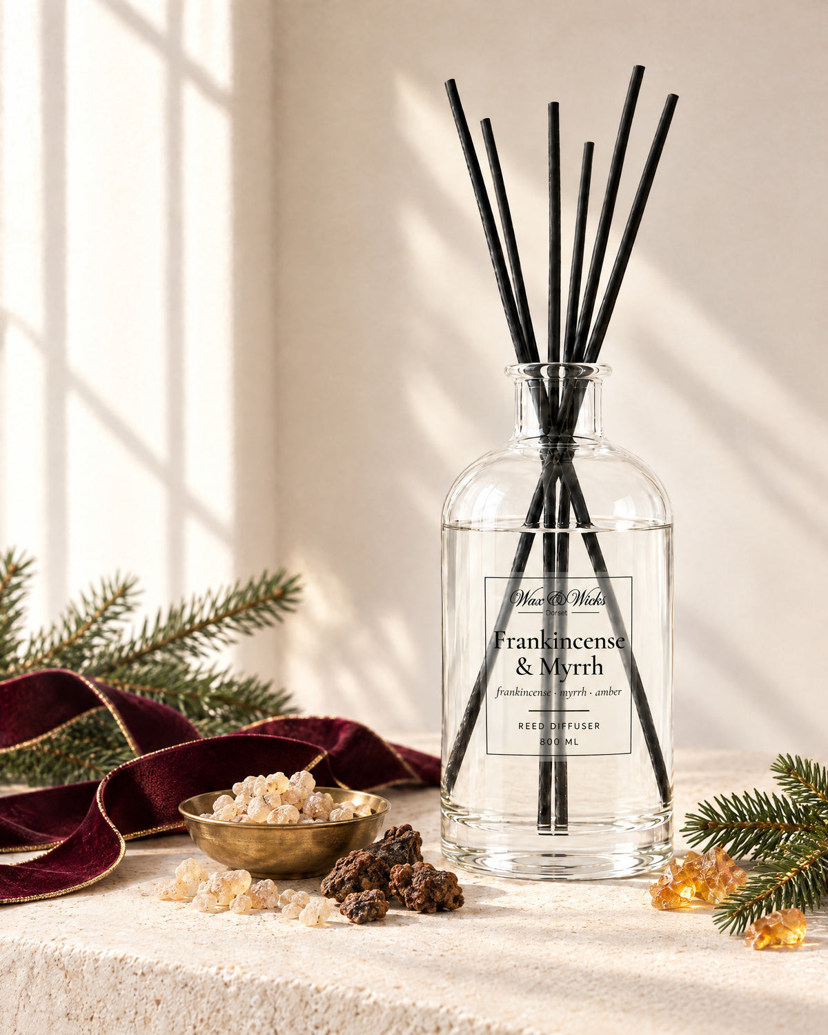 Frankincense & Myrrh 800 ml large reed diffuser in apothecary-style glass with extra-long reeds, styled with frankincense and myrrh resin, a fir sprig and burgundy ribbon