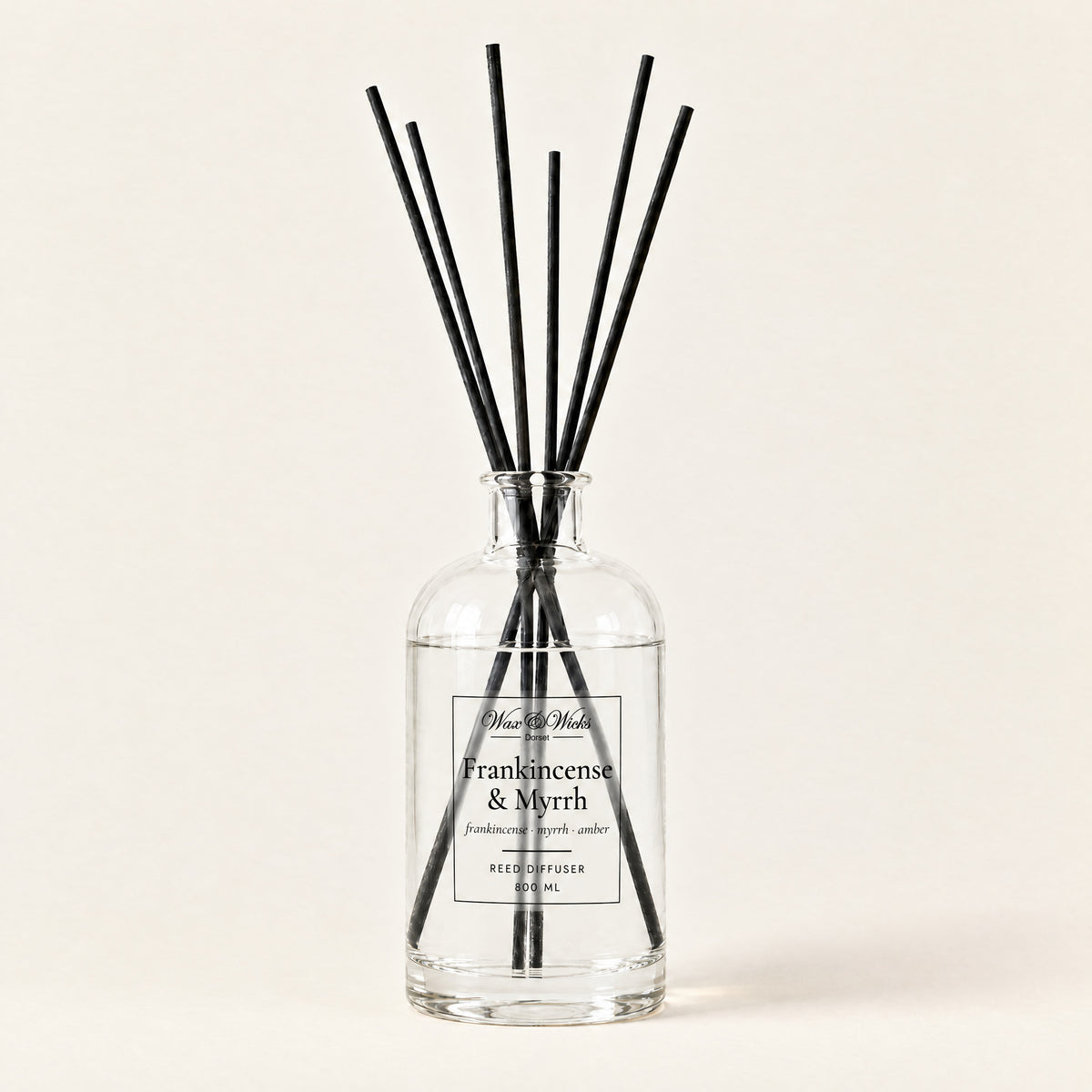 Frankincense & Myrrh 800 ml large reed diffuser in apothecary-style glass with extra-long reeds, on a plain ivory background