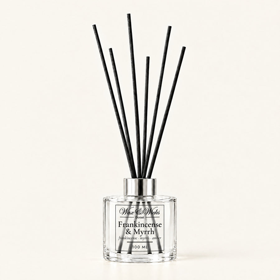 Frankincense & Myrrh 100 ml reed diffuser with black fibre reeds, on a plain ivory background