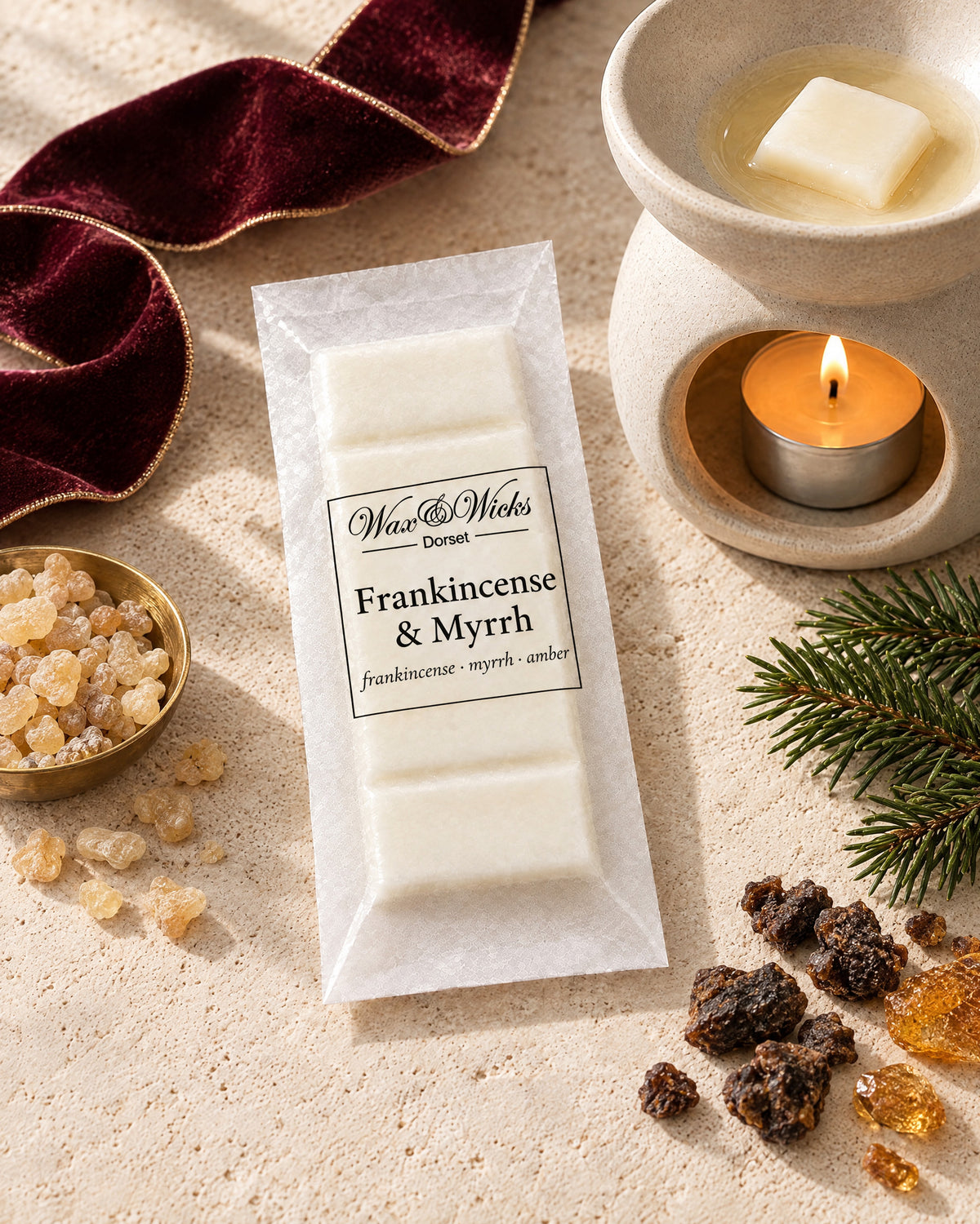Frankincense & Myrrh wax melt snap bar, styled with frankincense and myrrh resin, a fir sprig and burgundy ribbon