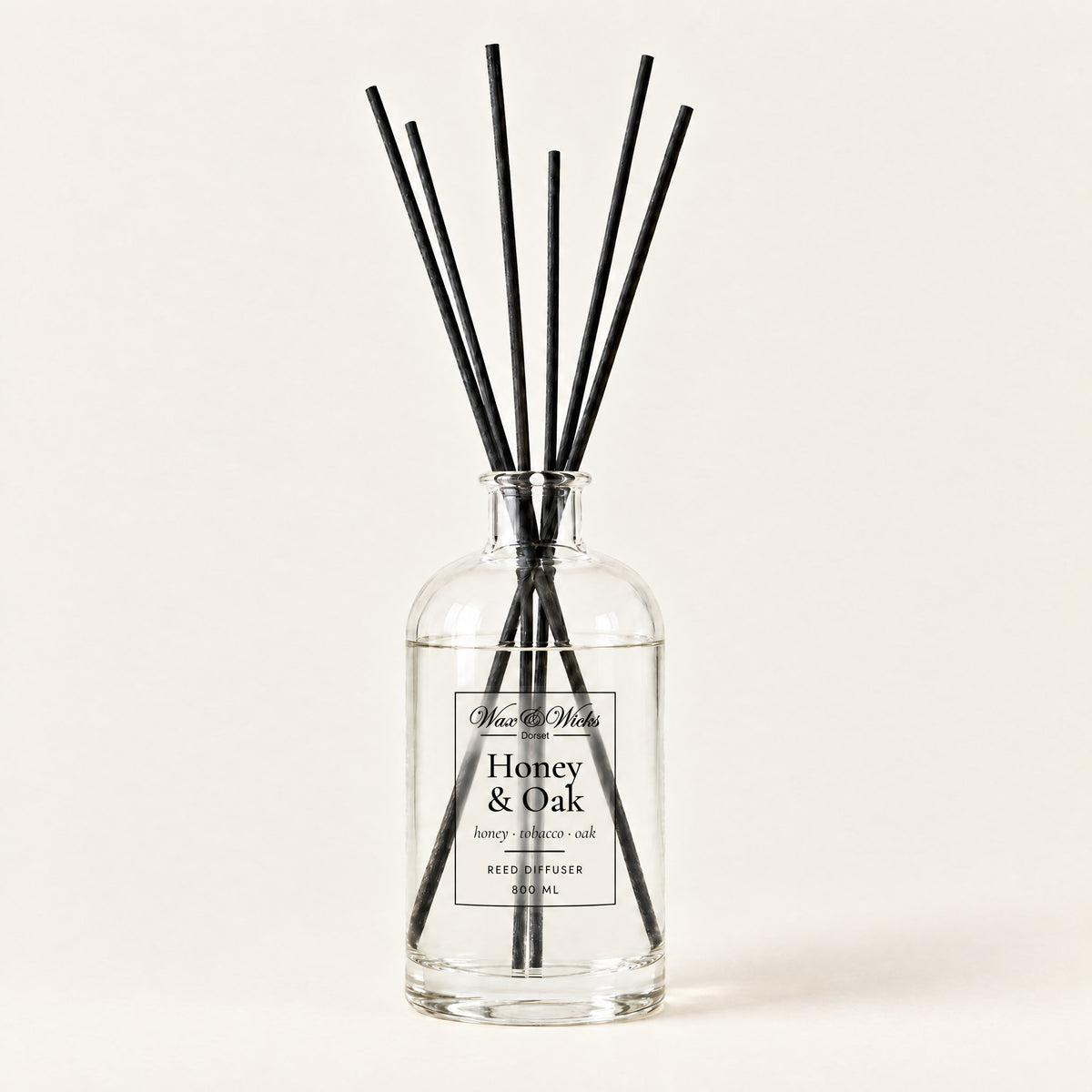 Honey & Oak 800 ml large reed diffuser in apothecary-style glass with extra-long reeds, on a plain ivory background
