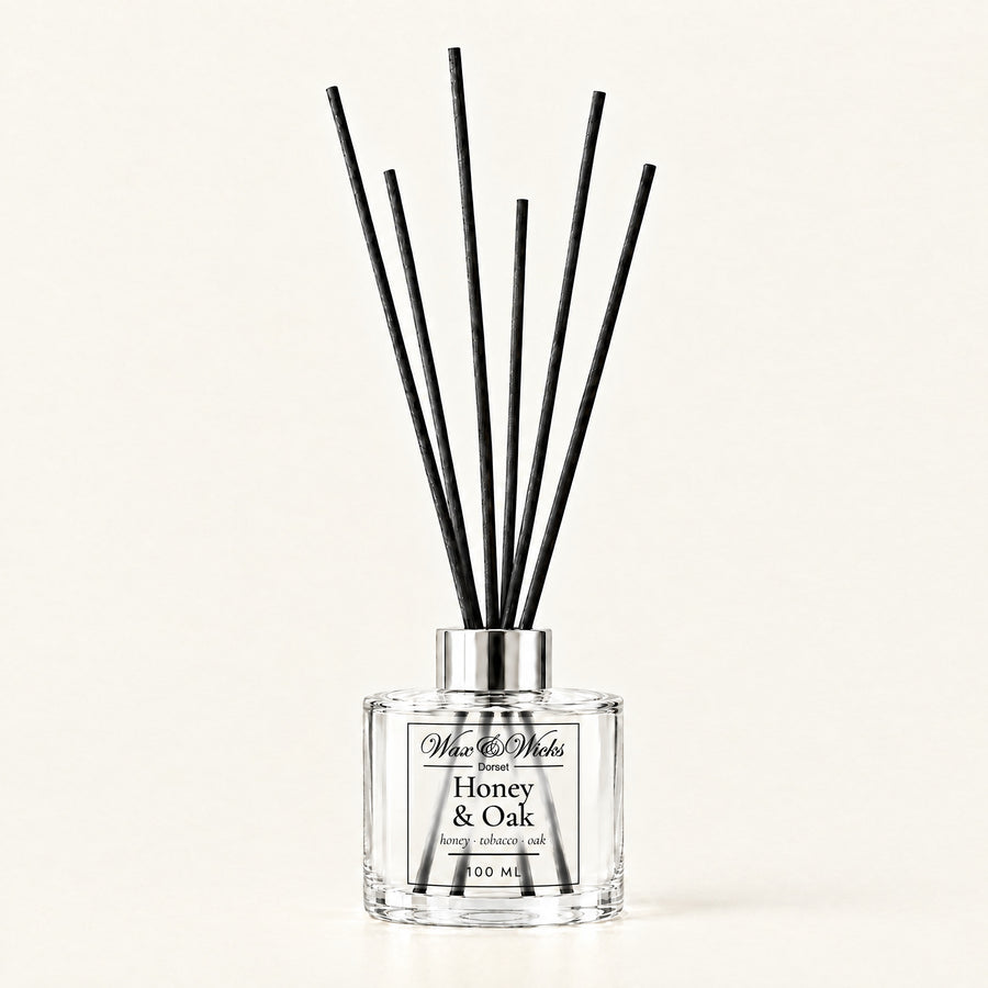 Honey & Oak 100 ml reed diffuser with black fibre reeds, on a plain ivory background