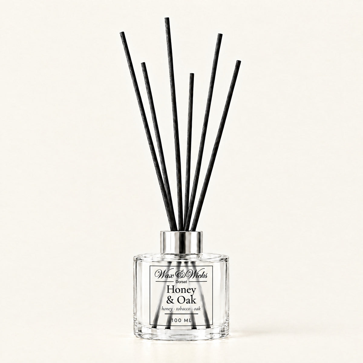 Honey & Oak 100 ml reed diffuser with black fibre reeds, on a plain ivory background