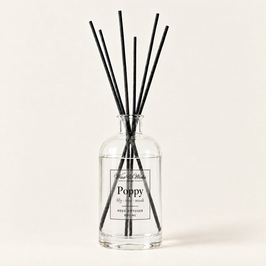 Poppy 800 ml large reed diffuser in apothecary-style glass with extra-long reeds, on a plain ivory background