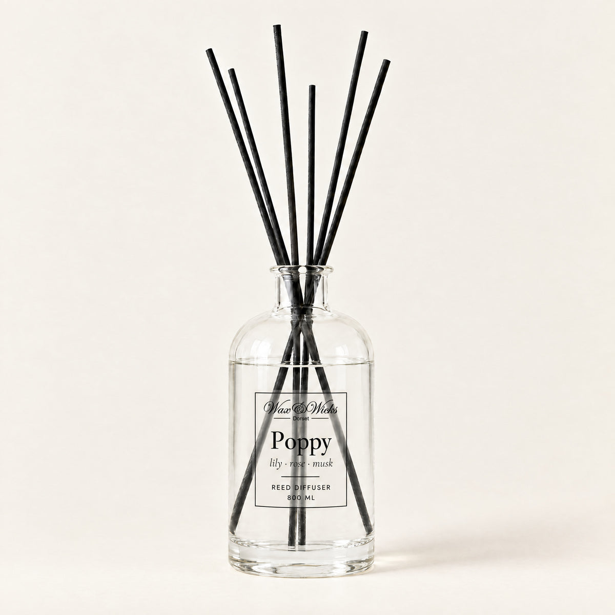 Poppy 800 ml large reed diffuser in apothecary-style glass with extra-long reeds, on a plain ivory background
