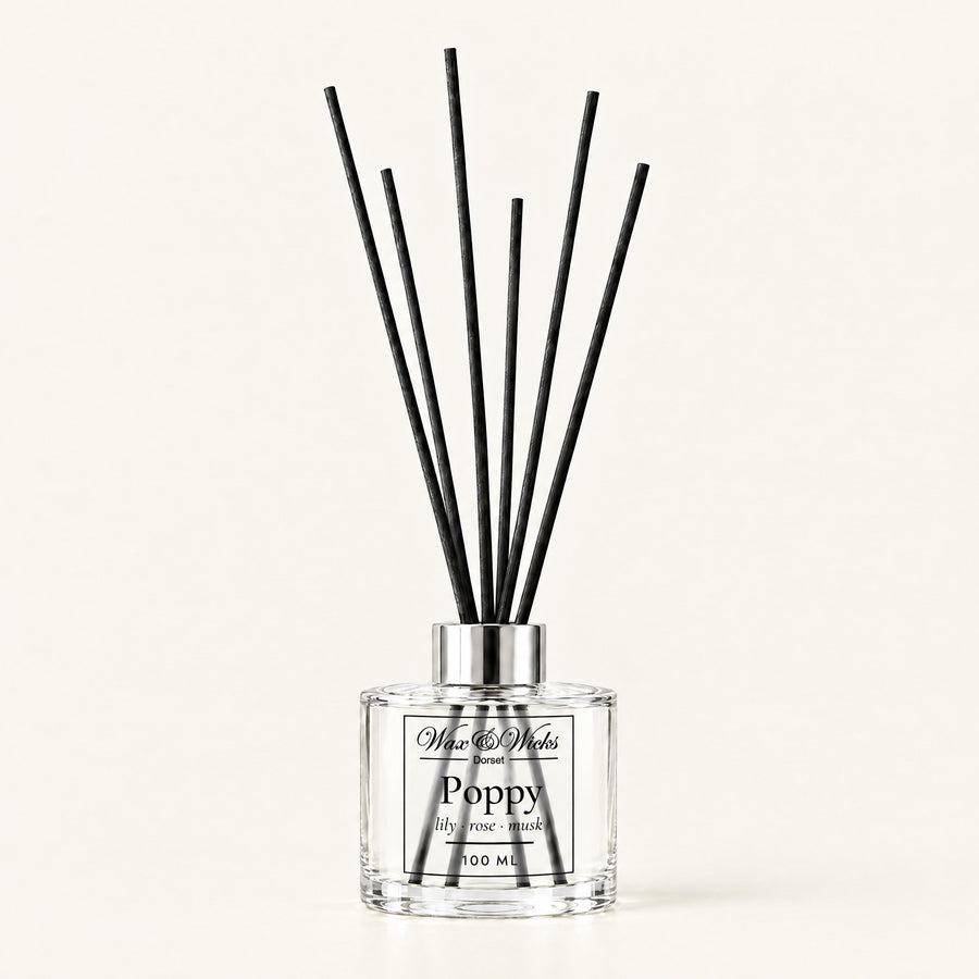 Poppy 100 ml reed diffuser with black fibre reeds, on a plain ivory background