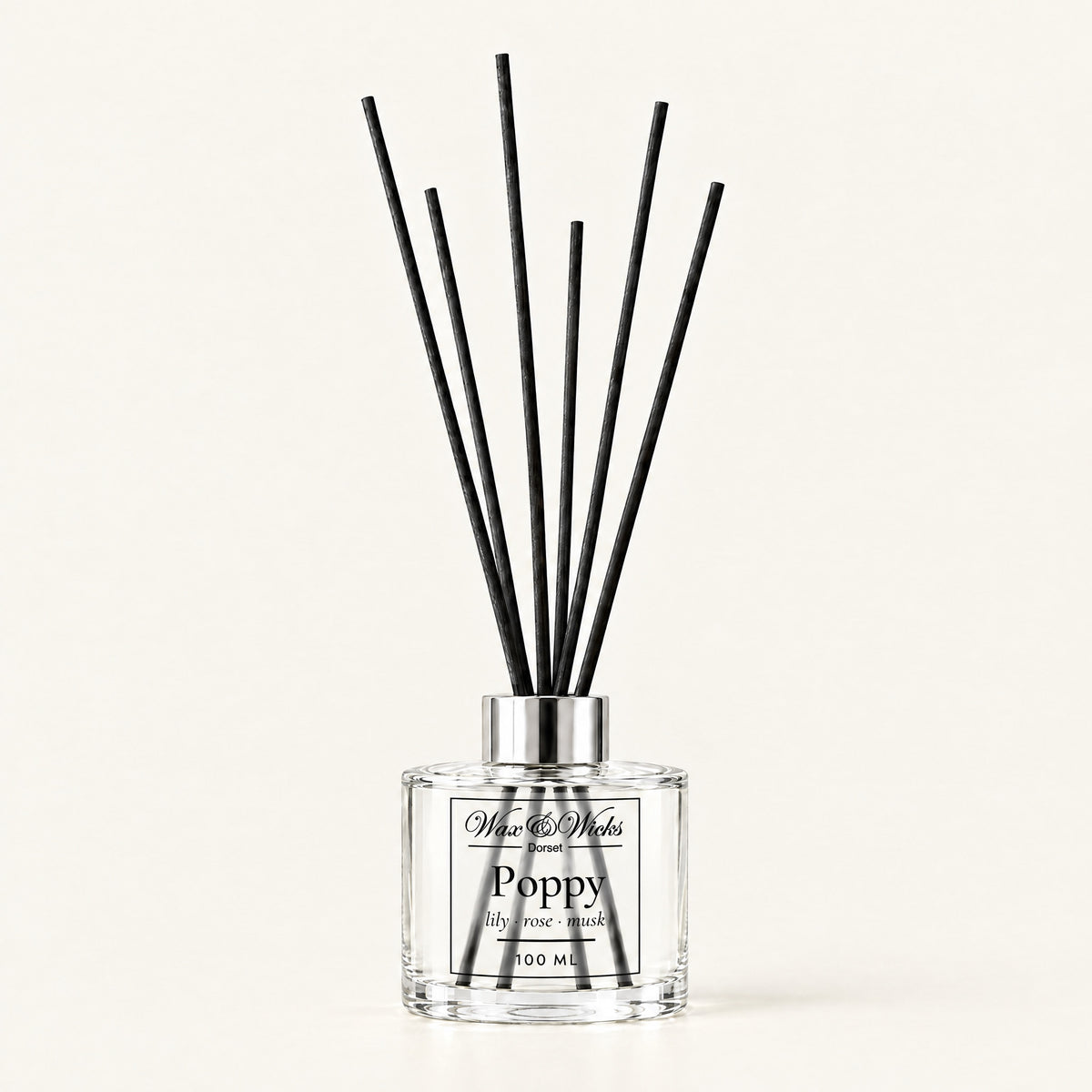 Poppy 100 ml reed diffuser with black fibre reeds, on a plain ivory background