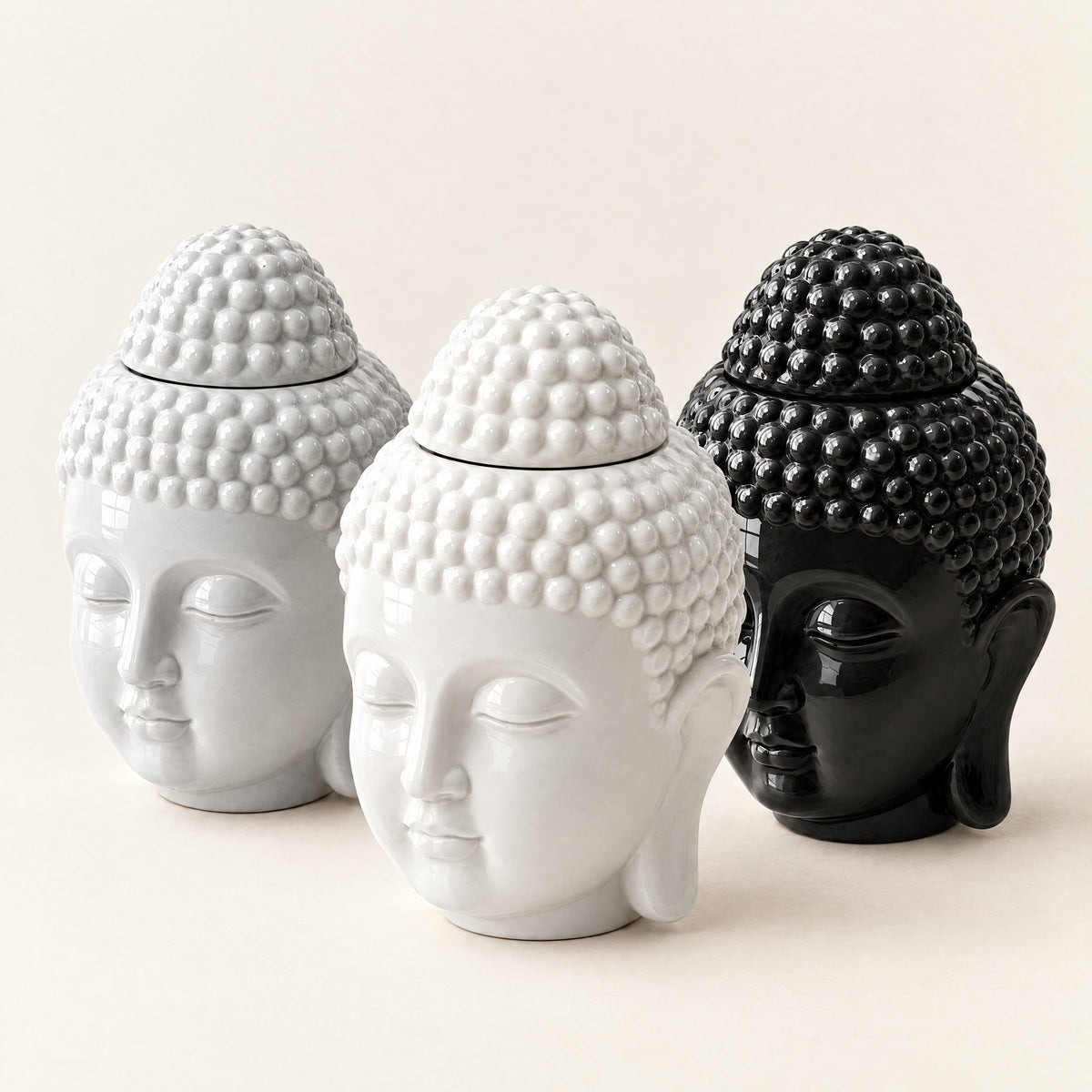 Prince Buddha wax melt burners in white, grey and black, side by side on a plain ivory background