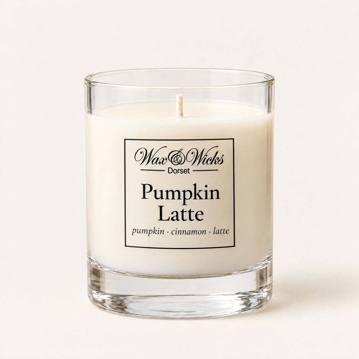 Small Pumpkin Latte candle, one wick, in a clear glass jar, on a plain ivory background
