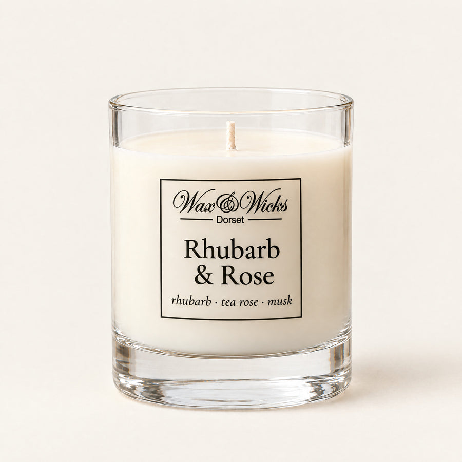 Small Rhubarb & Rose candle, one wick, in a clear glass jar, on a plain ivory background