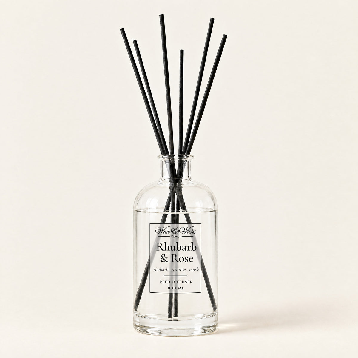 Rhubarb & Rose 800 ml large reed diffuser in apothecary-style glass with extra-long reeds, on a plain ivory background