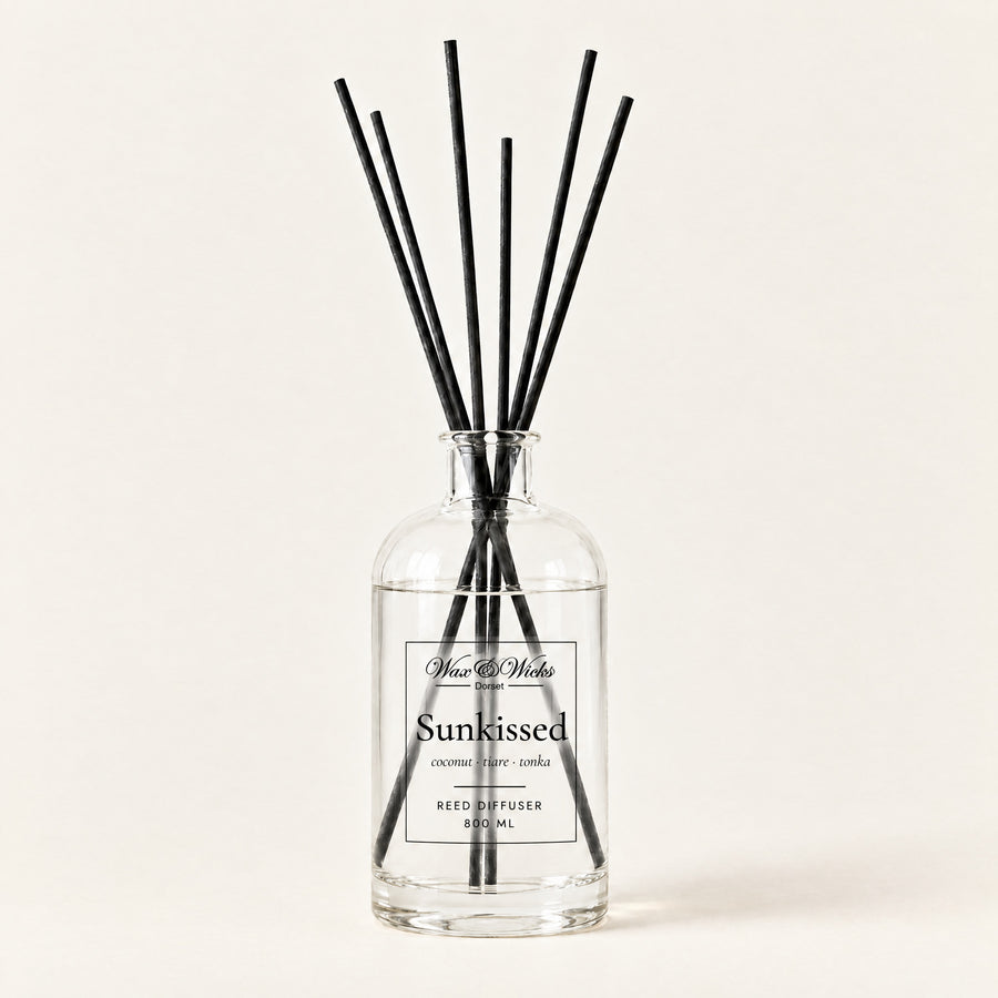 Sunkissed 800 ml large reed diffuser in apothecary-style glass with extra-long reeds, on a plain ivory background