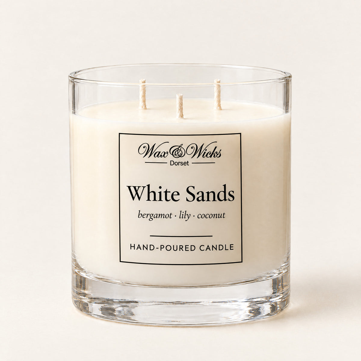 Large White Sands candle, three wicks, in a clear glass jar, on a plain ivory background