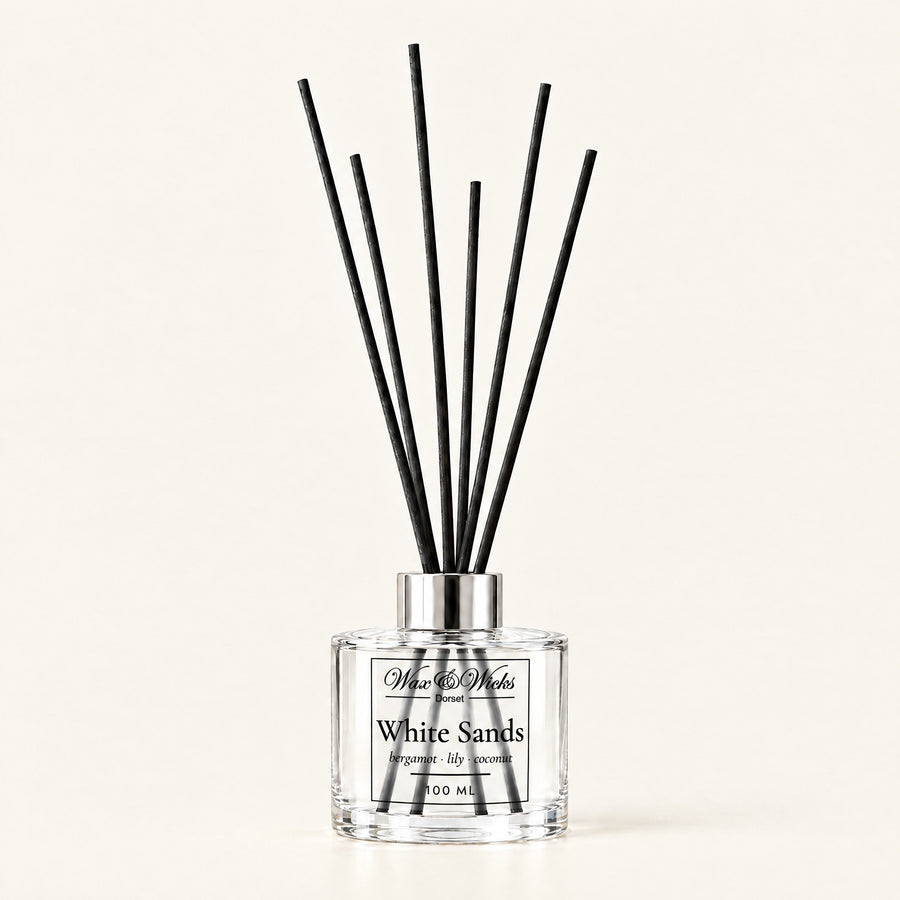 White Sands 100 ml reed diffuser with black fibre reeds, on a plain ivory background