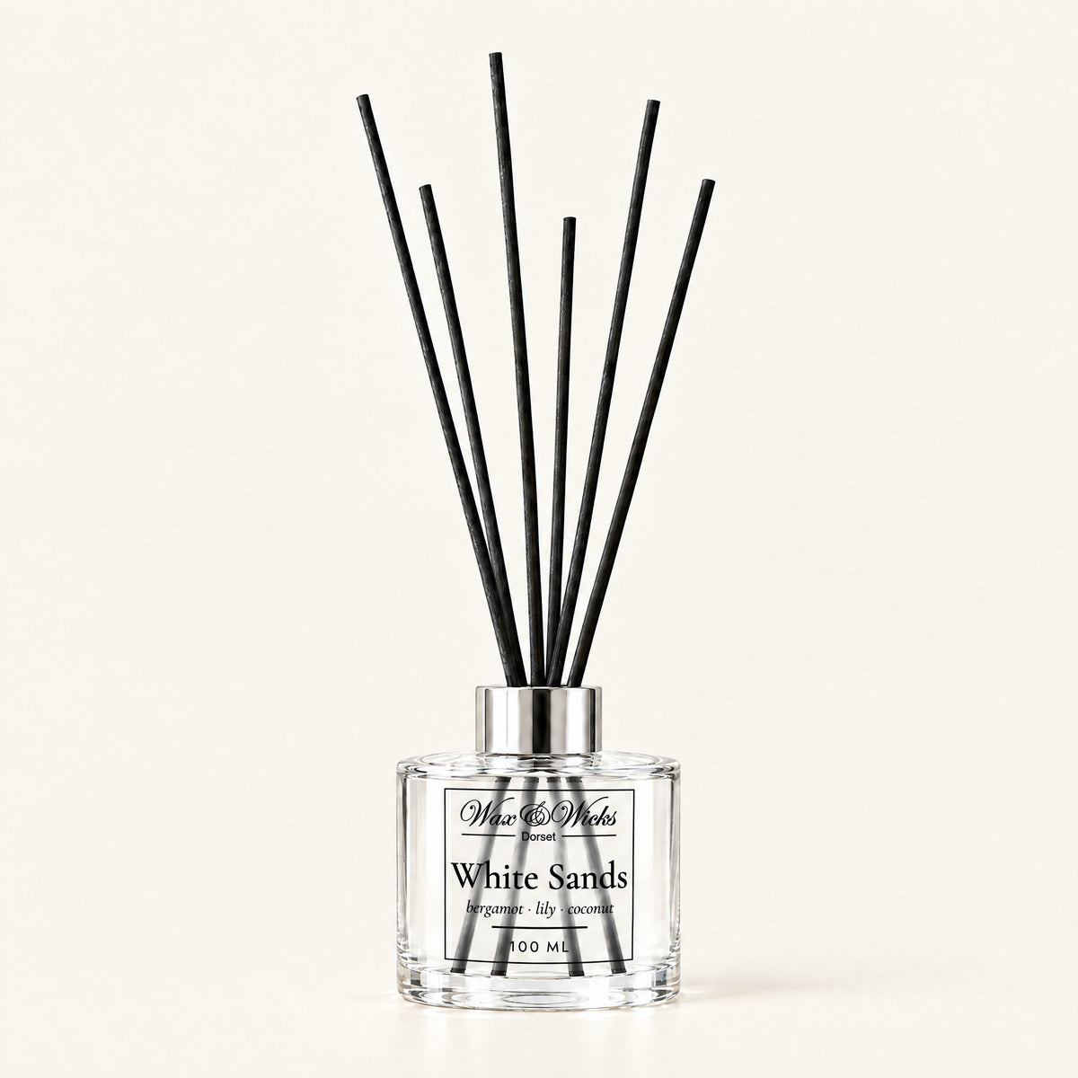 White Sands 100 ml reed diffuser with black fibre reeds, on a plain ivory background
