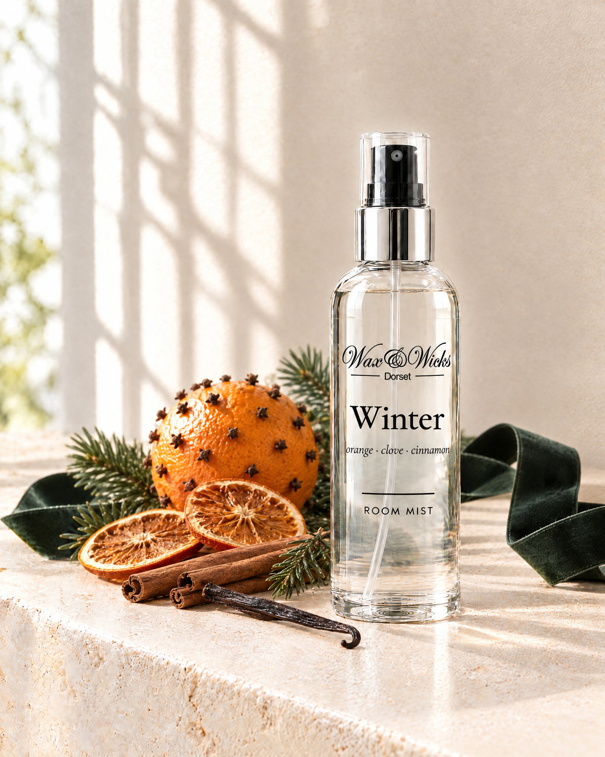 Winter room mist, 100 ml spray bottle, styled with a clove-studded orange, dried orange slices, cinnamon sticks and fir